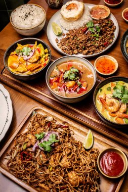 mixed traditional cuisine popular thai food dishes on bangkok restaurant table indoors