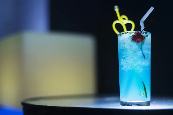 Blue curacao cocktail drink with cherry at night — Stock Photo, Image