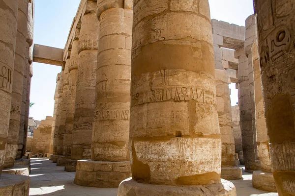 KARNAK TEMPLE - Massive columns inside beautiful Egyptian landmark with hieroglyphics, and ancient symbols. Famous landmark in the world near the Nile River and Luxor, Egypt