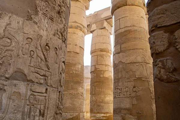 KARNAK TEMPLE - Massive columns inside beautiful Egyptian landmark with hieroglyphics, and ancient symbols. Famous landmark in the world near the Nile River and Luxor, Egypt