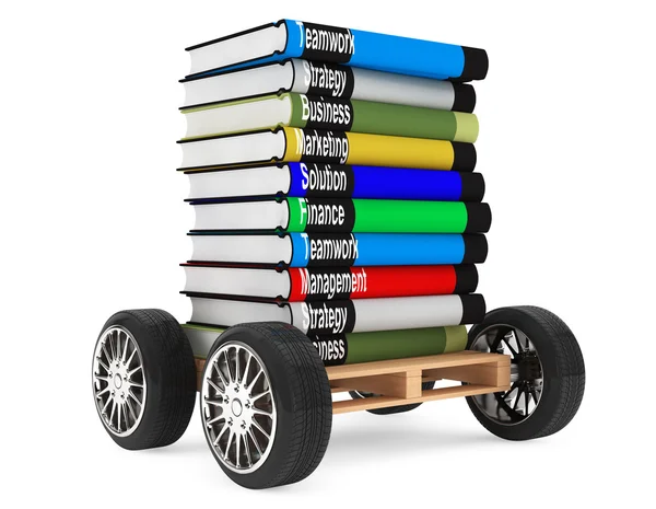 Pilha de livros com rodas de carro — Fotografia de Stock