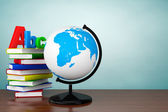 Old Style Photo. Books with ABC sign and World desktop globe