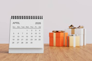 White Desk Monthly April 2026 Business Calendar Near Gift Boxes on a white background. 3d Rendering