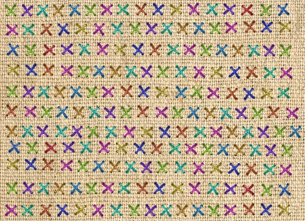 Close up of colorful cross stitch detail on designer cushion