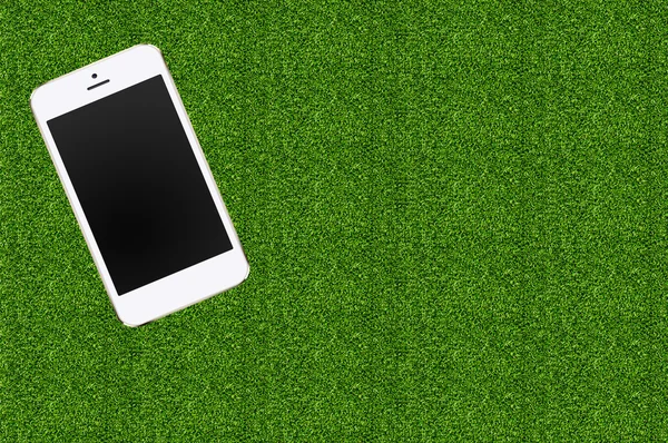 obile phone in the green grass