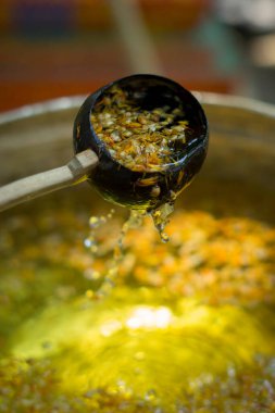 Hindistancevizi kabuğundan yapılmış su kepçesi antik kil su kabarcığında odun saplı.