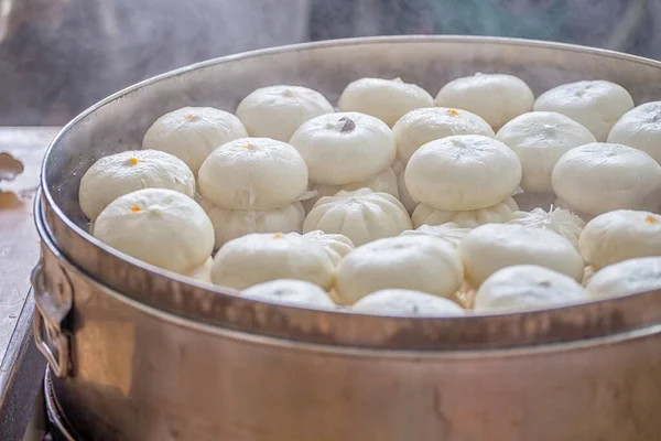 Delicious baozi, thai steamed meat bun is ready to eat on serving plate and steamer