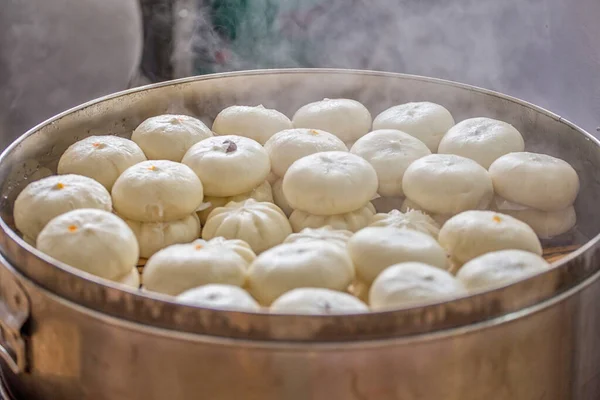 Delicious baozi, thai steamed meat bun is ready to eat on serving plate and steamer