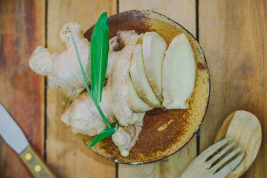 Tahta masada zencefil kökü dilimlenmiş.