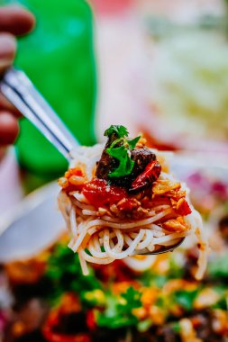 Baharatlı domuz soslu pilav. Tayland 'ın kuzeyinde yerel yemek. Baharatlı domuz soslu pirinç şehriyesi ve domates.