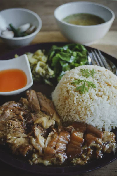 木製のテーブルの上にサイドボウルとご飯の上に煮込みポークレッグ タイ料理 — ストック写真