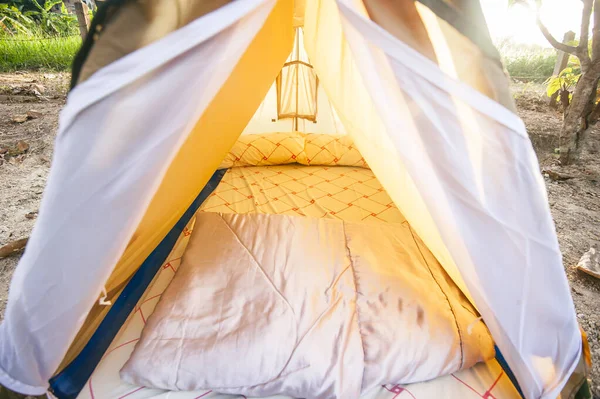 military tent in the open meadow. Against the background of trees