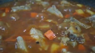 Man cooking and stir hot pork stew.Tasty beef meat stewed with potatoes