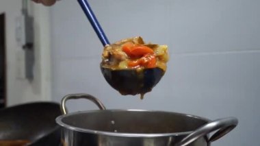 Man cooking and stir hot pork stew.Tasty beef meat stewed with potatoes