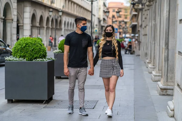 wedding couple walking through the city with the mask on