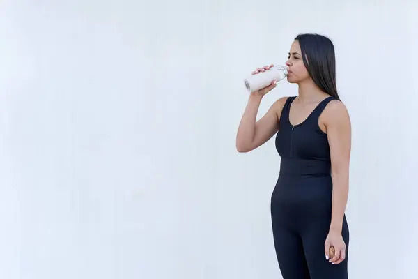 Młoda kobieta ze sprawną wodą do picia — Zdjęcie stockowe