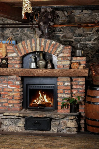 Wood burning in a fireplace to warm the house. Christmas New Year concept decorations. A fireplace in old house