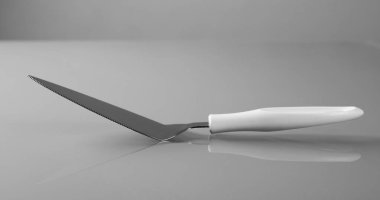 Gri arka planda çelik metal mutfak spatulası