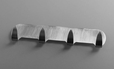 Gri arka planda metal yapıştırıcı kancalar. Havlu askıları.