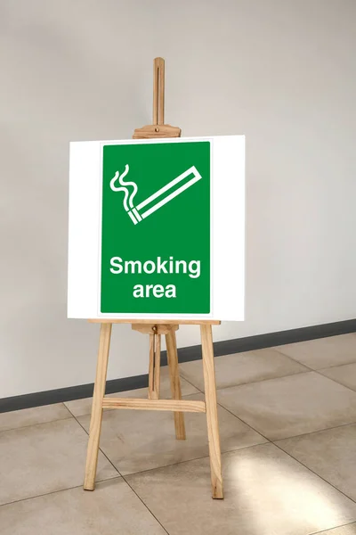 This is a designated smoking area sign on a board in front of the restaurant entrance. Designated smoking area sign on a board