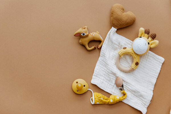  Set of baby stuff and accessories for newborn on brown background. Baby shower or baby care  concept. Flat lay, top view
