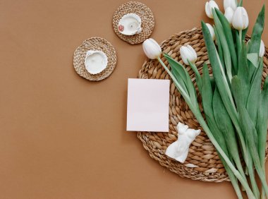 Tebrik kartı, bahar kompozisyonu. Kahverengi arka planda beyaz laleler ve mum. Anneler Günü, 8 Mart. Boş tebrik kartı. Düz Yat, Durgun Yaşam Bileşimi