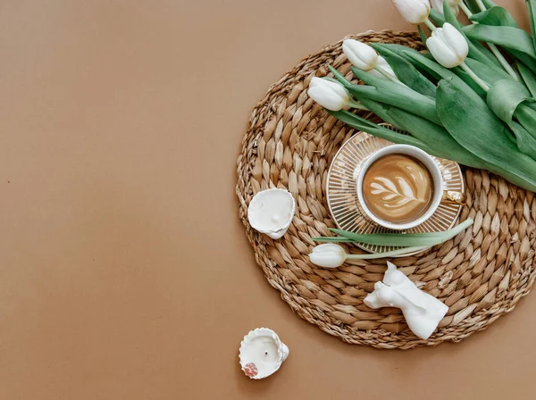 Coffee cup and bouquet of white tulips . Concept of holiday, birthday, Women Day. Romantic Feminine flat lay. Good morning. still life.