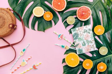 Summer travel tropical frame with Ratan bag and fruits. Vacation concept flat lay. Top view. Copy space