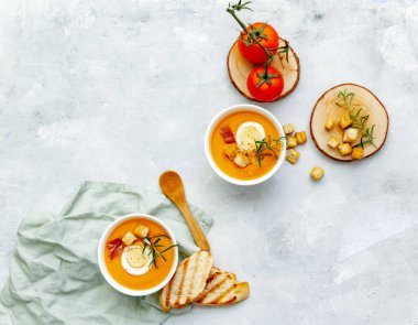 Beyaz mermer masa üstünde Gaspacho çorbası ya da İspanyol salmorejosu. Hafif arka planda geleneksel Endülüs soğuk çorba püresi kaseleri. Üst görünüm veya düz uzanma.