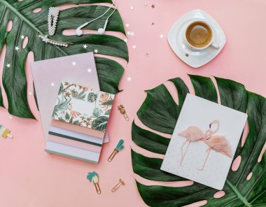 Flat lay woman Pink tropical office desk table with notebook, computer keyboard and coffee. Creative blogger concept