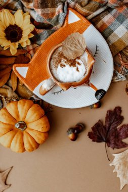 Sonbahar ya da Sonbahar kompozisyonu. Sonbahar yaprakları, kahverengi arka planda sıcak bir fincan kahve. Ruh hali, yaşam tarzı, natürmort. Düz yatıyordu