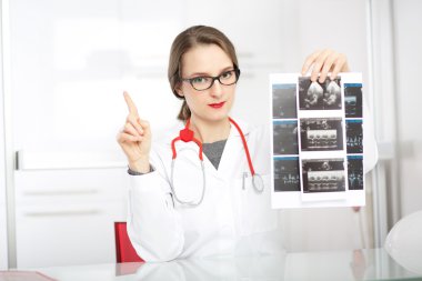 female doctor showing ultrasound clipart
