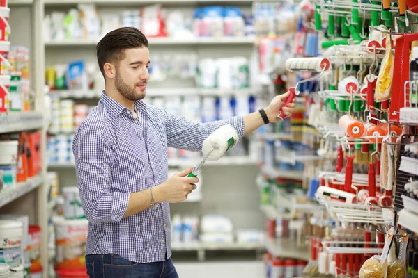 Young man working in a hardware store Stock Image