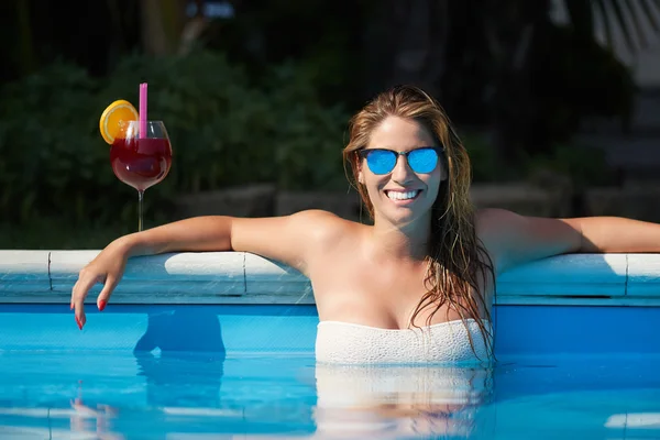 Mujer joven relajándose en la piscina — Foto de Stock