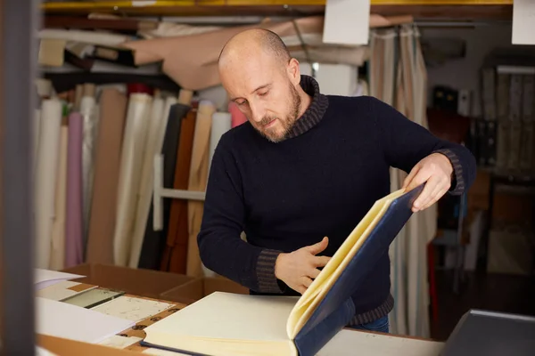 book binder working in a craft workshop