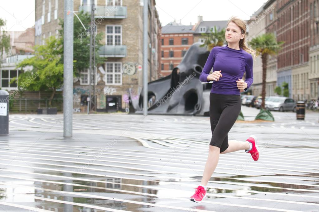 running woman at Superkilen Parc - Copenhagen Denmark in summer