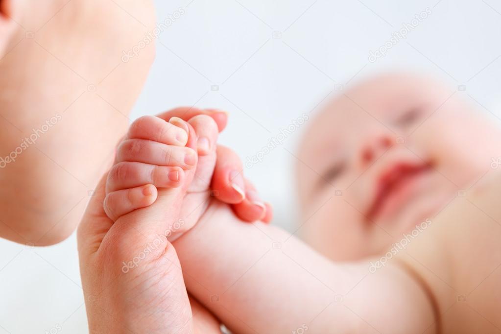 concept of parental love. baby hand holding  finger of mother