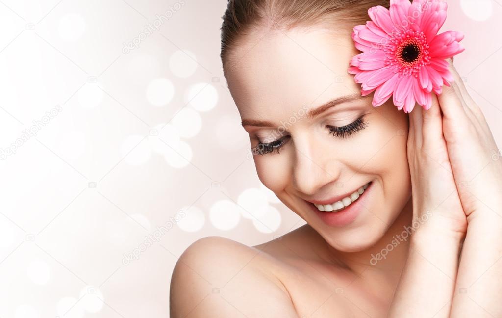 beauty natural  young girl with flower pink gerbera