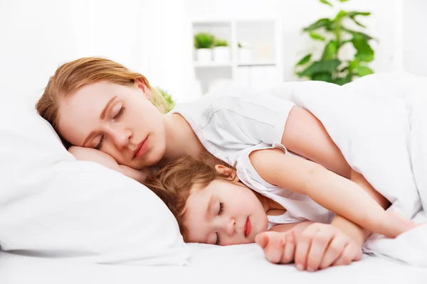 Gelukkige familie moeder en kind slapen in bed — Stockfoto