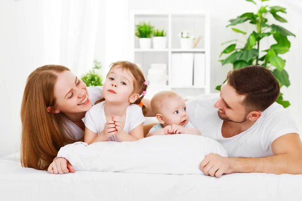 Familia feliz en casa en la cama —  Fotos de Stock