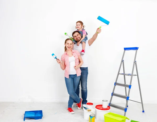 Happy family mother father and baby daughter are doing repairs p — Stock Photo, Image