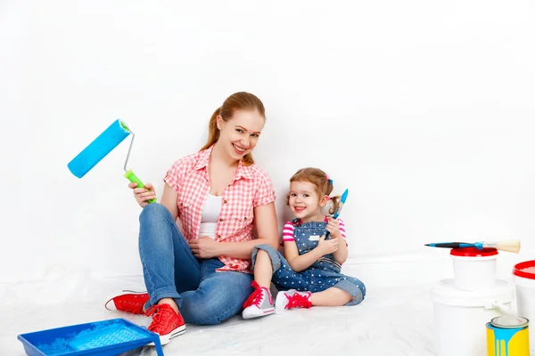 Happy family mother and child daughter making repairs, paint wal — Stock Photo, Image