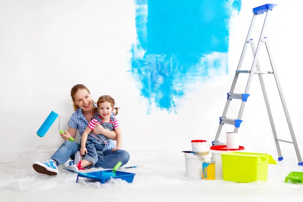 Happy family mother and child daughter making repairs, paint wal — Stock Photo, Image