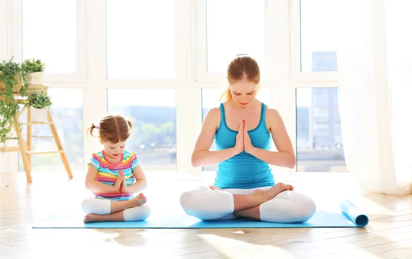 Family mother and child daughter are engaged in meditation and y — Stock Photo, Image