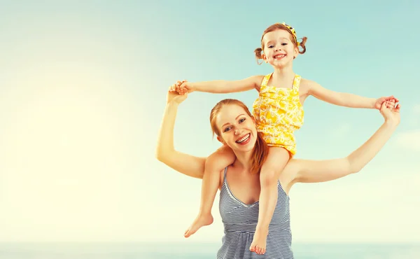 Happy family mother and child daughter on beach — Stock Photo, Image