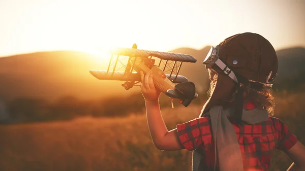 Glückliches Kind träumt vom Reisen und Spielen mit dem Flugzeug — Stockfoto