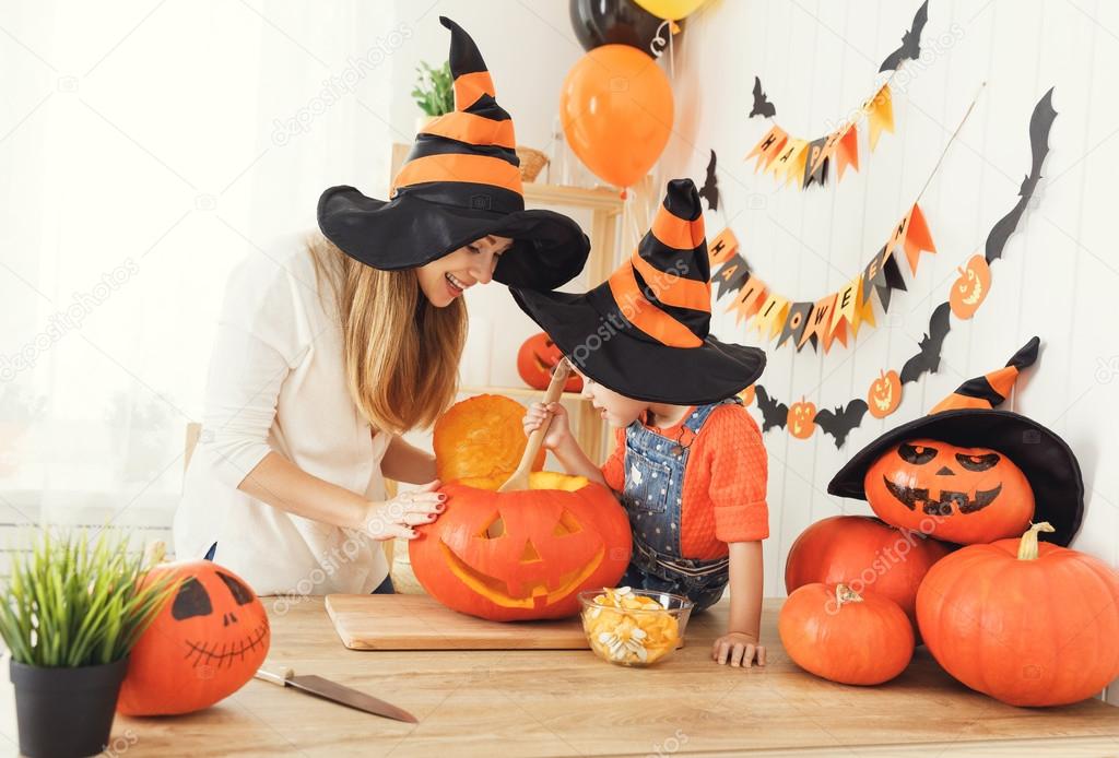 family mother and child daughter in hat witch are preparing for 