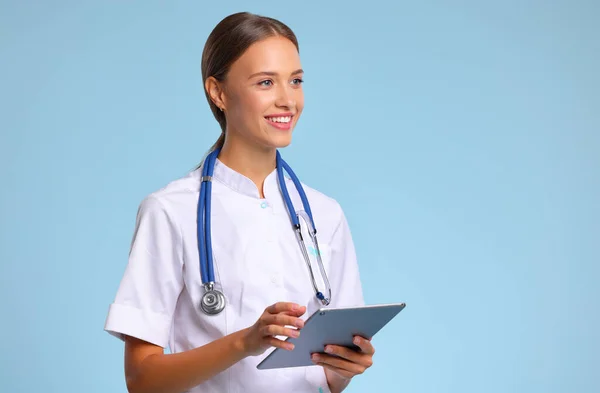 Friendly Doctor Nurse Tablet Wireless Computer Smiles Isolated Blue Backgroun — Stock Photo, Image