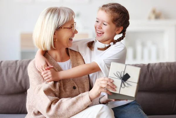 Optimistická Dívka Objímající Šťastné Starší Ženy Přítomností Při Chlazení Gauči — Stock fotografie