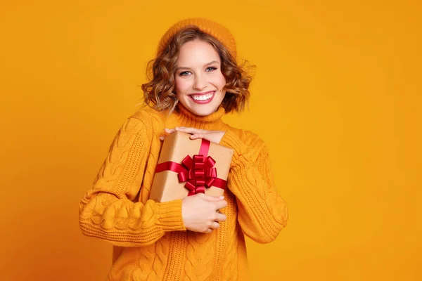 Alegre Mujer Joven Divertida Suéter Amarillo Sombrero Sonriendo Sostiene Regalo — Foto de Stock